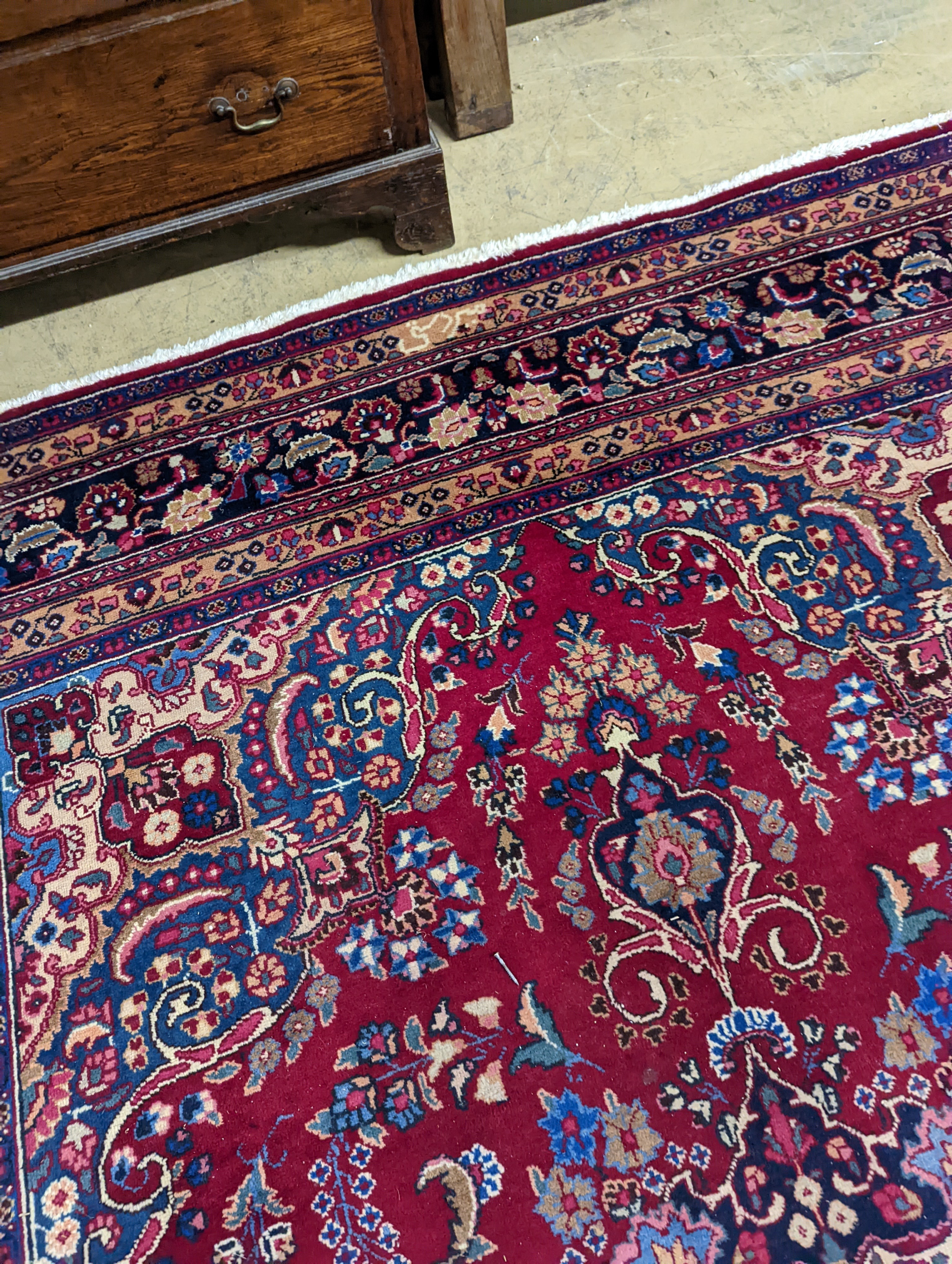 A Tabriz burgundy ground carpet, 350 x 250cm